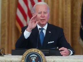 U.S. President Joe Biden responds to questions from reporters as he meets with his Competition Council in the East Room of the White House in Washington, January 24, 2022.