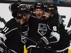 L.A. Kings' Dustin Brown (centre) celebrates with center Anze Kopitar (left) and defenceman Drew Doughty (right) after scoring a goal against the Minnesota Wild in the third period at Staples Center in Los Angeles, Feb. 21, 2021.
