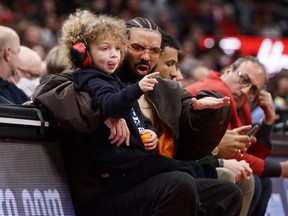 Rapper Drake and his son Adonis take in the Game 6 of the Eastern Conference First Round between the Toronto Raptors and the Philadelphia 76ers at Scotiabank Arena on April 28, 2022.