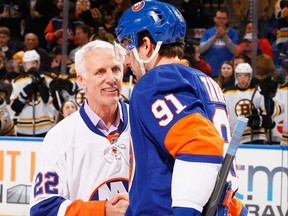 In this 2015 photo, former New York Islander Mike Bossy greets John Tavares prior to the game during Mike Bossy Tribute Night at the Nassau Veterans Memorial Coliseum in Uniondale, N.Y.