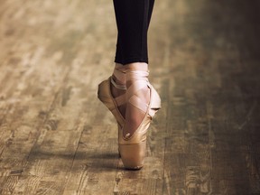 Feet of ballerina in training shoes.