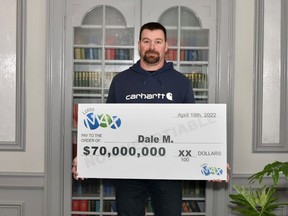 Dale McEwen is pictured with his $70 million cheque in the photo provided by the Western Canada Lottery Corporation.