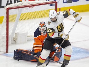 Edmonton Oilers goalie Mike Smith (41) makes q save with Vegas Golden Knights Keegan Kolesar (55) in front of him during first period NHL action on Saturday, April 16, 2022 in Edmonton.