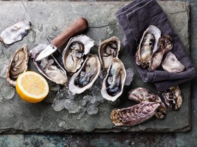 Oysters on stone plate with ice and lemon are pictured in a file photo.