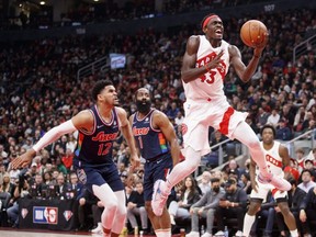 Raptors' Pascal Siakam, right, drives to the net as Tobias Harris of the 76ers pursues during the first half of Game Four of the Eastern Conference First Round series at Scotiabank Arena in Toronto, Saturday, April 23, 2022.