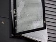 A broken window riddled with bullet holes is seen outside an Airbnb apartment rental in Pittsburgh, Sunday, April 17, 2022.