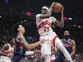 Toronto Raptors forward Chris Boucher (25) rebounds the ball against Philadelphia 76ers forward Danny Green (14) during Game 3 of the first round of the 2022 NBA playoffs at Scotiabank Arena.