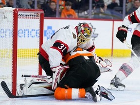 Flyers forward Scott Laughton collides with Senators goalie Anton Forsberg during the second period of Friday’s game. A Flyers goal was called back as a result of the play.  Matt Slocum/AP PHOTO
