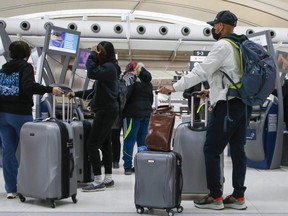 Travellers at Pearson International Airport on March 11, 2022.