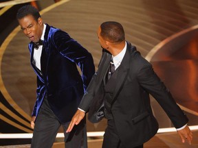 Will Smith hits Chris Rock as Rock spoke on stage during the 94th Academy Awards in Hollywood, Los Angeles, Calif., March 27, 2022.