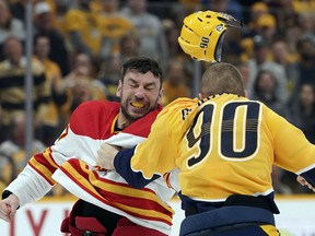 Flames forward Milan Lucic and the Nashville Predators' Mark Borowiecki fight in the first period of Tuesday night's NHL game in Nashville.