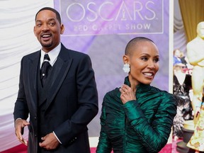 Will Smith and Jada Pinkett Smith pose on the red carpet during the Oscars arrivals at the 94th Academy Awards in Hollywood, Calif., March 27, 2022.