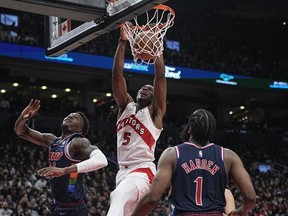 Toronto Raptors forward Precious Achiuwa dunks the ball against Philadelphia 76ers forward Paul Reed and guard James Harden during the second half of game three of the first round for the 2022 NBA playoffs at Scotiabank Arena.
