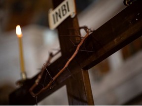 A crown of thorns is placed on a crucifix during the procession of Jesus Christ's Deposition from the Cross, in Athens, Greece, April 17, 2020.