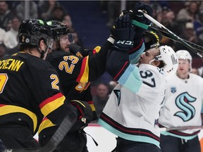 Vancouver Canucks' Oliver Ekman-Larsson (23) and Seattle Kraken's Yanni Gourde (37) get into a scuffle after the whistle during the second period of an NHL hockey game in Vancouver, on Tuesday, April 26, 2022.