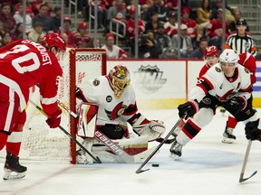 Detroit Red Wings centre Oskar Sundqvist puts the puck in front of the net against Ottawa Senators goaltender Anton Forsberg and defenceman Nick Holden during the second period at Little Caesars Arena on Tuesday night.