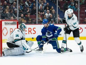 Apr 9, 2022; Vancouver, British Columbia, CAN; San Jose Sharks goaltender Kaapo Kahkonen (34) makes a save in front of defenseman Jaycob Megna (24) and Vancouver Canucks right wing Alex Chiasson (39) during the first period at Rogers Arena. Mandatory Credit: Derek Cain-USA TODAY Sports