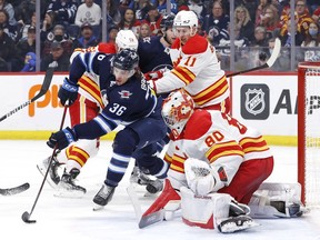 Winnipeg Jets centre Morgan Barron gets set to take a shot on Calgary Flames goaltender Dan Vladar at Canada Life Centre in Winnipeg on Friday, April 29, 2022.