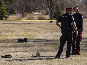 Police investigate the scene outside of McNally High School near the bus stop on Friday, April 8, 2022 in Edmonton. A witness saw a young man being taken away on a stretcher while receiving chest compressions.