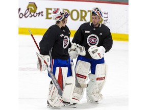 Canadiens' Jake Allen, right, chats with fellow netminder Sam Montembeault, during a practice at the Bell Sports Complex in Brossard on Jan. 10, 2022.