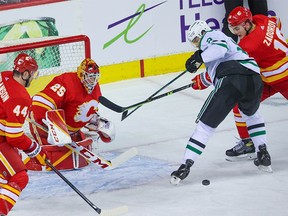 Calgary Flames goaltender Jacob Markstrom and Flames players Erik Gudbranson and Nikita Zadorov stop a Dallas Stars shot during Game 5 of their Stanley Cup playoff series in Calgary on Wednesday, May 11, 2022.
