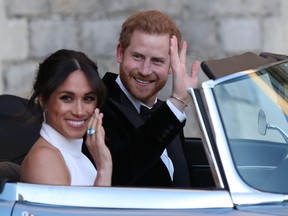 Meghan, Duchess of Sussex and Prince Harry wave as they leave Windsor Castle after their wedding to attend an evening reception at Frogmore House, hosted by the Prince of Wales on May 19, 2018 in Windsor, England. (Photo by Steve Parsons - WPA Pool/Getty Images)