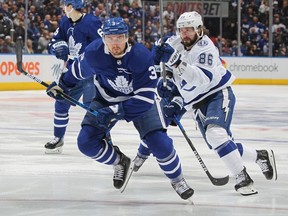 Nikita Kucherov of the Tampa Bay Lightning skates against Justin Holl of the Toronto Maple Leafs during Game Five of the First Round of the 2022 Stanley Cup Playoffs at Scotiabank Arena on May 10, 2022 in Toronto, Ontario, Canada.