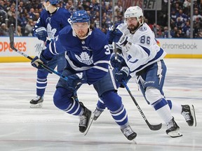 Nikita Kucherov of the Tampa Bay Lightning skates against Justin Holl of the Toronto Maple Leafs during Game Five of the First Round of the 2022 Stanley Cup Playoffs at Scotiabank Arena on May 10, 2022 in Toronto, Ontario, Canada.