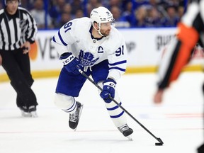 John Tavares of the Toronto Maple Leafs looks to pass in the third period during Game Four of the First Round of the 2022 Stanley Cup Playoffs against the Tampa Bay Lightning at Amalie Arena on May 08, 2022 in Tampa, Florida.