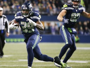Running back Mike Davis of the Seattle Seahawks rushes against the Atlanta Falcons during the game at CenturyLink Field on November 20, 2017 in Seattle, Washington.