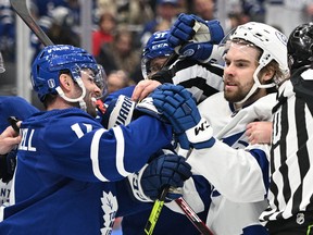 Toronto Maple Leafs forward Colin Blackwell (11) pushes Tampa Bay Lightning forward Nicholas Paul (20) in game one of the first round of the 2022 Stanley Cup Playoffs at Scotiabank Arena