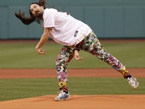 American DJ Steve Aoki delivers the first pitch before the game between the Boston Red Sox and the Houston Astros at Fenway Park on May 16, 2022 in Boston, Massachusetts.