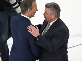 Tampa Bay Lightning coach Jon Cooper, left, warned that if the Leafs break up their core members, his team would try to pick them up. USA TODAY SPORTS