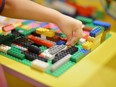 Child playing building with coloured blocks