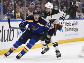 Minnesota Wild left wing Nicolas Deslauriers pressures St. Louis Blues defenseman Niko Mikkola during the second period in Game 4 of the first round of the 2022 Stanley Cup Playoffs at Enterprise Center in St. Louis, Miss., May 8, 2022.