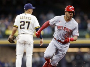 Reds left fielder Tommy Pham (right) rounds second base during the first inning against the Brewers at American Family Field in Milwaukee, May 4, 2022.