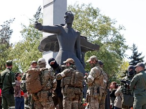 Service members of pro-Russian troops during a ceremony, marking the 77th anniversary of the victory over Nazi Germany in the Second World War, in Mariupol, Ukraine May 9, 2022.