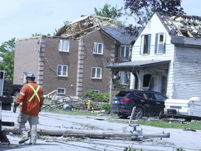Residents of Uxbridge clean up after Saturday's storm that destroyed residential and commercial properties on May 23, 2022.
