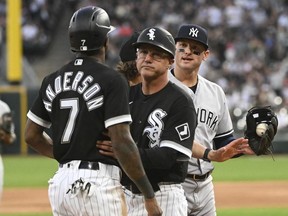 May 13, 2022; Chicago, Illinois, USA; Chicago White Sox shortstop Tim Anderson (7) is held back by Chicago White Sox third base coach Joe McEwing (47) after having an altercation with New York Yankees third baseman Josh Donaldson (28, right) during the first inning at Guaranteed Rate Field.