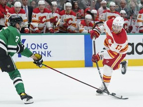 Dallas Stars defenceman John Klingberg deflects a shot by Calgary Flames forward Johnny Gaudreau during Game 3 of their first-round playoff series at American Airlines Center in Dallas on Saturday, May 7, 2022.