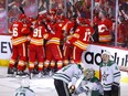 The Calgary Flames celebrate after Johnny Gaudreau scored the overtime winner to defeat the Dallas Stars in the deciding Game 7 of their first-round playoff series at Scotiabank Saddledome in Calgary on Sunday, May 15, 2022.
