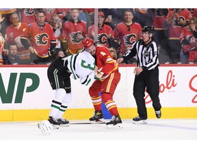 May 3, 2022; Calgary, Alberta, CAN; Calgary Flames defenseman Rasmus Andersson (4) fights Dallas Stars defenseman John Klingberg (3) during the first period in game one of the first round of the 2022 Stanley Cup Playoffs at Scotiabank Saddledome. Mandatory Credit: Candice Ward-USA TODAY Sports