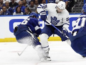 May 8, 2022; Tampa, Florida, USA; Tampa Bay Lightning right wing Nikita Kucherov (86) and Toronto Maple Leafs defenseman Mark Giordano (55) go after the loose puck during the second period of game four of the first round of the 2022 Stanley Cup Playoffs at Amalie Arena.