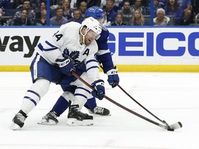Toronto Maple Leafs defenseman Morgan Rielly defends Tampa Bay Lightning left wing Brandon Hagel during the third period of game four of the first round of the 2022 Stanley Cup Playoffs at Amalie Arena.