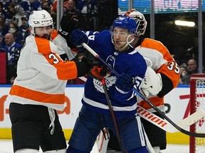 Toronto Maple Leafs forward Michael Bunting and Philadelphia Flyers defenseman Keith Yandle battle for position during the third period at Scotiabank Arena.