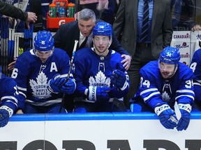 Toronto Maple Leafs head coach Sheldon Keefe congratulates Mitchell Marner and forward Michael Bunting on assisting on the goal by forward Auston Matthews against the Tampa Bay Lightning during the third period of game five of the first round of the 2022 Stanley Cup Playoffs at Scotiabank Arena.