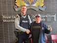 Kelowna RCMP Const. Mike Della-Paolera returns the 1979 Wayne Gretzky rookie hockey card to Ian Moore. It was stolen in 2015 and finally returned to its owner last week.