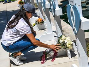 Meghan Markle, the wife of Prince Harry, places flowers as she mourns at a makeshift memorial outside Uvalde County Courthouse in Uvalde, Texas, on May 26, 2022.