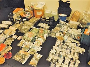 This handout photo shows a number of drugs, cash and gold bars that were seized in an investigation that took place from September to December 2021 and involved B.C. RCMP and FBI agents in California. Six people were arrested as part of the investigation.