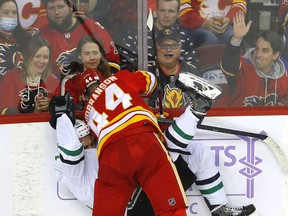 Flames defenceman Erik Gudbranson battles the Dallas Stars' Radek Faksa in NHL action at the Scotiabank Saddledome in this photo from Nov. 4, 2021.